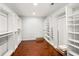 Large walk-in closet with custom shelving and dark wood floors at 4699 Price St, Forest Park, GA 30297