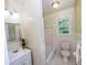 Clean bathroom with white fixtures, a window for natural light, and a shower at 87 Valley Rd, Lawrenceville, GA 30044