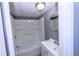 Bathroom featuring a shower-tub combo, white vanity, and round mirror at 87 Valley Rd, Lawrenceville, GA 30044