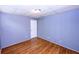 Bedroom features beautiful hardwood floors, a white door, a ceiling light and bead board walls at 87 Valley Rd, Lawrenceville, GA 30044