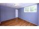Bedroom features beautiful hardwood floors, a white door, a window, and bead board walls at 87 Valley Rd, Lawrenceville, GA 30044
