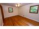 Inviting bedroom featuring hardwood floors, dual windows, and neutral color palette at 87 Valley Rd, Lawrenceville, GA 30044