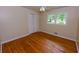 Bright bedroom features hardwood floors, white trim, a window, and a closet for ample storage at 87 Valley Rd, Lawrenceville, GA 30044
