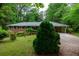 Charming brick home with manicured lawn, mature trees and a covered carport at 87 Valley Rd, Lawrenceville, GA 30044