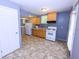 Functional kitchen features white appliances, ample countertop space, and hardwood cabinets at 87 Valley Rd, Lawrenceville, GA 30044