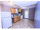 Bright kitchen features white appliances, ample countertop space, and hardwood cabinets at 87 Valley Rd, Lawrenceville, GA 30044