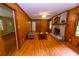 Cozy Gathering room with wood paneled walls, hardwood floors, and a brick fireplace at 87 Valley Rd, Lawrenceville, GA 30044