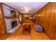 Comfortable Gathering room featuring hardwood floors, brick fireplace and wood paneling at 87 Valley Rd, Lawrenceville, GA 30044