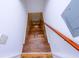 Stairway to the basement boasts white walls, wood treads, wood handrail, and white painted trim at 87 Valley Rd, Lawrenceville, GA 30044