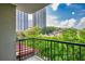 Outdoor balcony featuring a wrought iron railing that overlooks greenery and a tall building at 275 13Th Ne St # 409, Atlanta, GA 30309