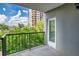 Outdoor balcony, featuring a wrought iron railing, overlooks greenery and a multi story building at 275 13Th Ne St # 409, Atlanta, GA 30309