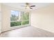 A cozy bedroom with a ceiling fan, large window, and hardwood floors at 275 13Th Ne St # 409, Atlanta, GA 30309