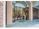 Close-up of the building's entrance, featuring a glass door, stone accents, and a modern design at 275 13Th Ne St # 409, Atlanta, GA 30309