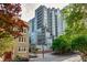 A modern condominium building with multiple balconies and large windows is surrounded by lush green trees at 275 13Th Ne St # 409, Atlanta, GA 30309