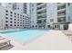 Inviting outdoor pool surrounded by lounge chairs and towering condos at 275 13Th Ne St # 409, Atlanta, GA 30309