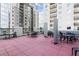 Community terrace with tables and chairs surrounded by high-rise buildings at 275 13Th Ne St # 409, Atlanta, GA 30309