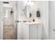 Clean bathroom with a vanity sink, oval mirror, and neutral color palette at 3510 Spring Valley Blvd, Atlanta, GA 30349