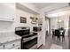 Efficient kitchen with sleek appliances, white cabinetry, and an adjacent dining area, great for entertaining at 3510 Spring Valley Blvd, Atlanta, GA 30349