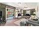 Open-concept living space with stylish furniture, a stone fireplace, and access to an outdoor patio at 3510 Spring Valley Blvd, Atlanta, GA 30349