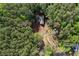 Aerial view of a home surrounded by trees in a heavily wooded area at 48 Paschal St, Temple, GA 30179