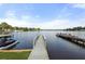 Scenic waterfront view featuring a private dock with watercraft and stunning lake views under a bright, partly cloudy sky at 48 Paschal St, Temple, GA 30179