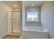 Bathroom featuring a soaking tub and glass door shower at 5 Camellia Dr, Fairburn, GA 30213