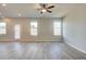 Spacious living area with modern flooring, natural light, and a ceiling fan at 5 Camellia Dr, Fairburn, GA 30213