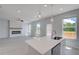 Bright living room has a modern fireplace and a sliding glass door that leads to an outdoor deck at 5 Camellia Dr, Fairburn, GA 30213