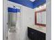 A newly remodeled bathroom showcases modern vanity, mirror, and blue accents on the walls and ceiling at 1206 Kincaid Rd, Marietta, GA 30066