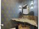 Powder room featuring a live edge vanity, unique wallpaper, statement sconces, and a glass vessel sink at 1206 Kincaid Rd, Marietta, GA 30066