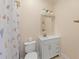 Small bathroom featuring a toilet, sink and vanity combo, and a shower with a patterned curtain at 1206 Kincaid Rd, Marietta, GA 30066