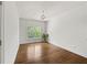 Bedroom featuring hardwood floors, a chandelier, a large window, and a green plant for natural decor at 1206 Kincaid Rd, Marietta, GA 30066