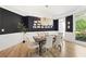 Elegant dining room with a modern chandelier, dark accent wall, and seating for six at 1206 Kincaid Rd, Marietta, GA 30066