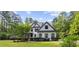 Beautiful two-story home with professionally landscaped front yard and large trees on a sunny day at 1206 Kincaid Rd, Marietta, GA 30066