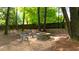 Backyard fire pit with seating, surrounded by a wooded area at 1206 Kincaid Rd, Marietta, GA 30066