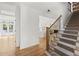 This foyer has hardwood floors and carpeted stairs with iron railing leading to the second floor at 1206 Kincaid Rd, Marietta, GA 30066