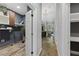Hallway featuring a mix of tile and hardwood flooring leading to an open laundry room and bathroom at 1206 Kincaid Rd, Marietta, GA 30066
