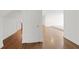 Hallway with hardwood floors leading to a brightly lit living area with white walls and trim at 1206 Kincaid Rd, Marietta, GA 30066