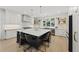 Bright kitchen featuring a large island with barstool seating, white cabinets, and stainless steel appliances at 1206 Kincaid Rd, Marietta, GA 30066