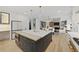 This kitchen offers an eat-in island with elegant pendant lights and seamlessly opens to the living room at 1206 Kincaid Rd, Marietta, GA 30066