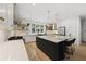 Spacious kitchen featuring a large island with seating, open shelving, and stainless steel appliances at 1206 Kincaid Rd, Marietta, GA 30066