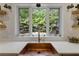 Kitchen featuring a view of the lush backyard from above a copper farmhouse style sink at 1206 Kincaid Rd, Marietta, GA 30066