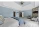 This bedroom features tray ceilings, ample windows, and sitting area near the stone fireplace at 1206 Kincaid Rd, Marietta, GA 30066