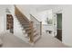 A carpeted staircase with metal railings ascends to the second floor with decorative wallpaper below the landing at 1206 Kincaid Rd, Marietta, GA 30066