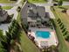 An aerial view of the property featuring a pool and outdoor living space in a landscaped backyard at 3024 Malbec Vly, Acworth, GA 30101