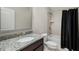 Well-lit bathroom showcases a vanity with granite countertop, tiled walls, and shower with a tub at 3024 Malbec Vly, Acworth, GA 30101