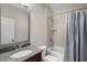 Well-lit bathroom showcases a vanity with granite countertop, tiled walls, and shower with a tub at 3024 Malbec Vly, Acworth, GA 30101