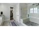 The gorgeous bathroom features a frameless shower and neutral tiling at 3024 Malbec Vly, Acworth, GA 30101