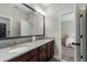 Bathroom featuring dual sinks with granite countertops and a view into an adjacent bedroom at 3024 Malbec Vly, Acworth, GA 30101