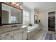 The bathroom features dual sinks, granite countertops and a soaking tub at 3024 Malbec Vly, Acworth, GA 30101